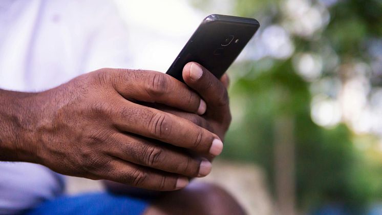 Stock image -Konnect_ person on mobile phone.JPG