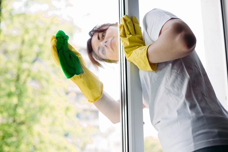 housemaid-wearing-white-t-shirt-yellow-protective-gloves-wiping-glass-with-rag-view-brunette-housewife-cleaning-big-dirty-window-concept-housework-apartment-service.webp