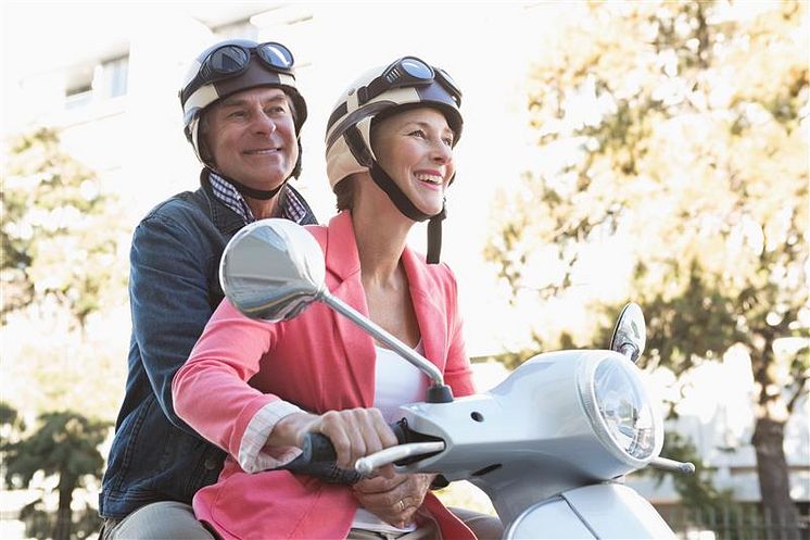 happy-senior-couple-riding-moped.jpg