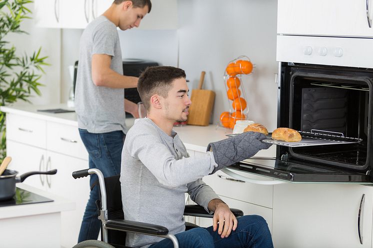 mp59677168-disabled-man-taking-food-from-oven.jpg
