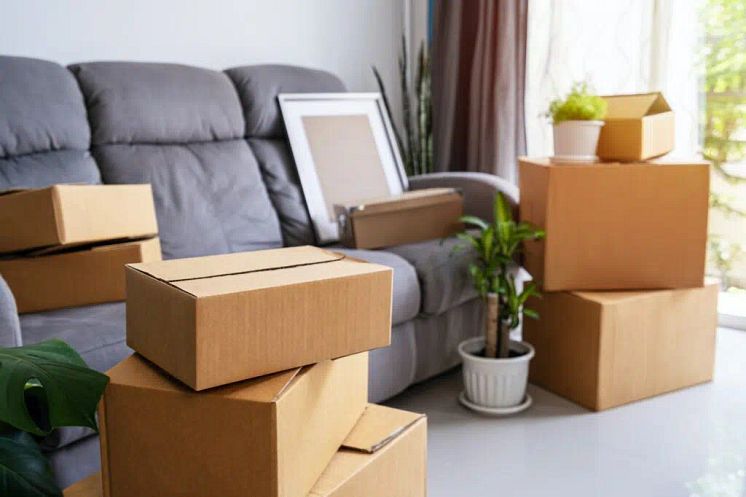 stack-of-cardboard-boxes-in-living-room-at-new-house-on-moving-day-1024x682.jpg