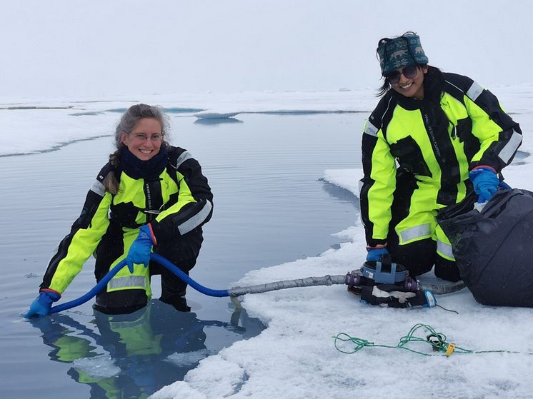 Eva Leu and Fowzia Ahmed taking water samples from a meltpond  by Janne Søreide.jpg