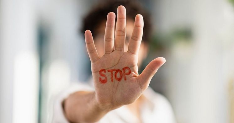 A raised hand with the word 'stop' written on it to symbolise stopping stigma behaviour (Getty Images)