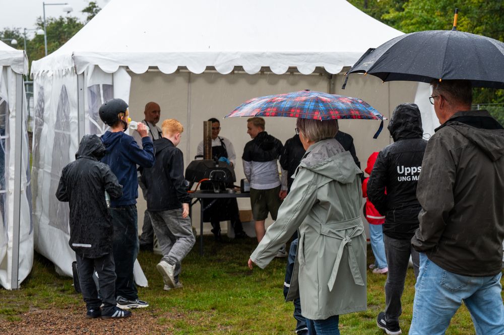 En grupp människor som står runt ett tält.