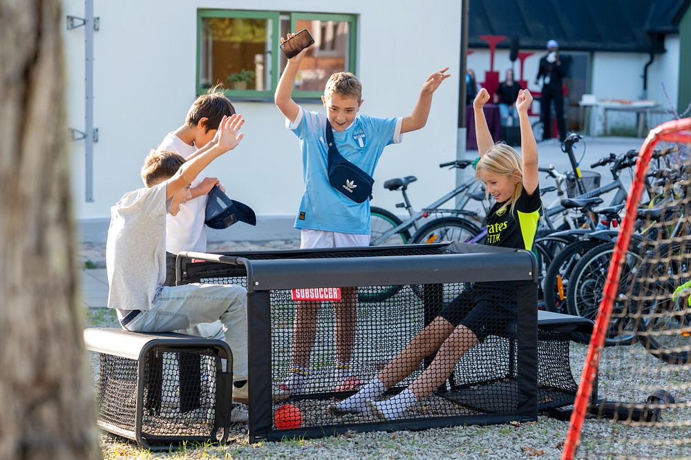 En grupp barn runt ett bord som har roligt.