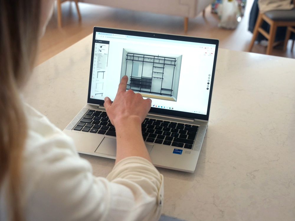 Person using Elfa’s online planning tool to design a wardrobe with shelves, rails and drawers.