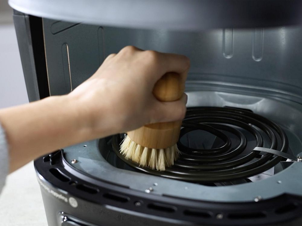 Värmeelementet på en Philips Airfryer rengörs med en mjuk borste